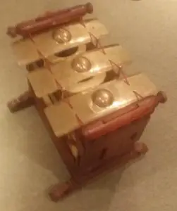 A wooden xylophone with three rows of bars